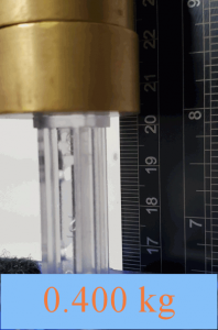 photo of masses sitting on compressed spring